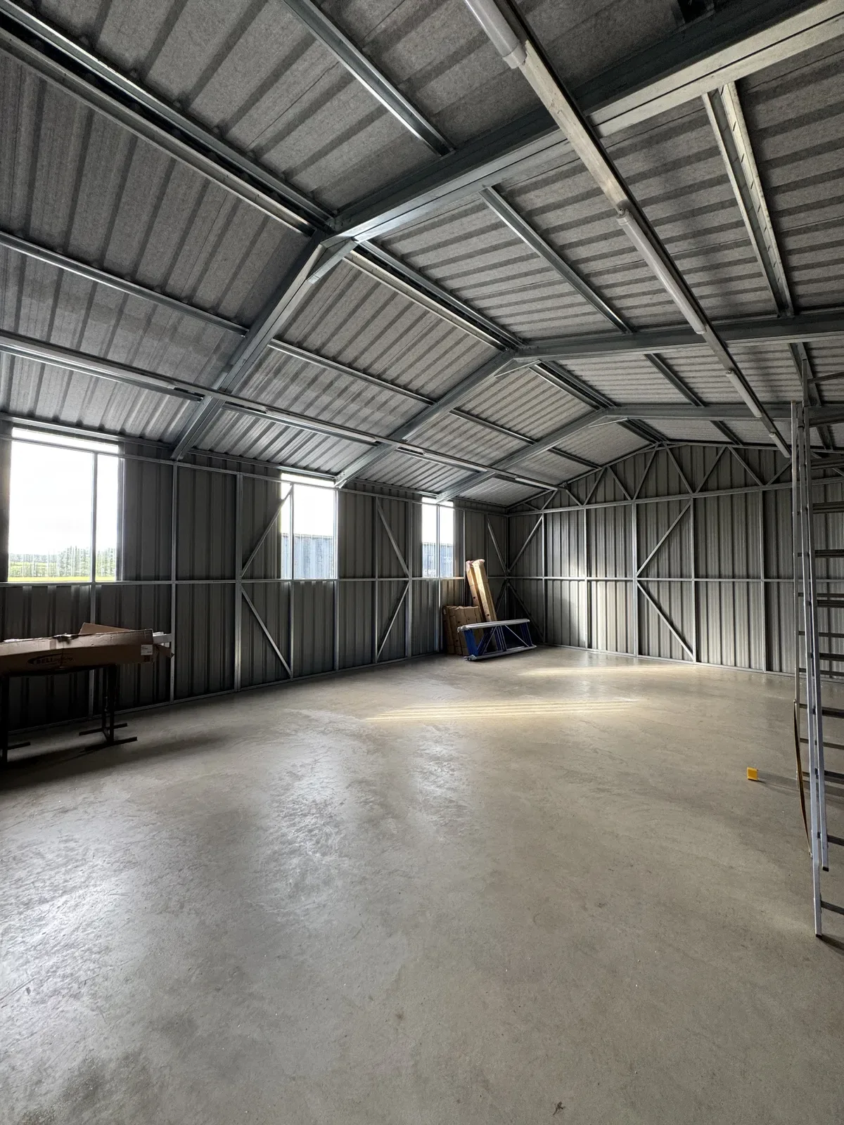 Steel workshop interior with windows and a workbench